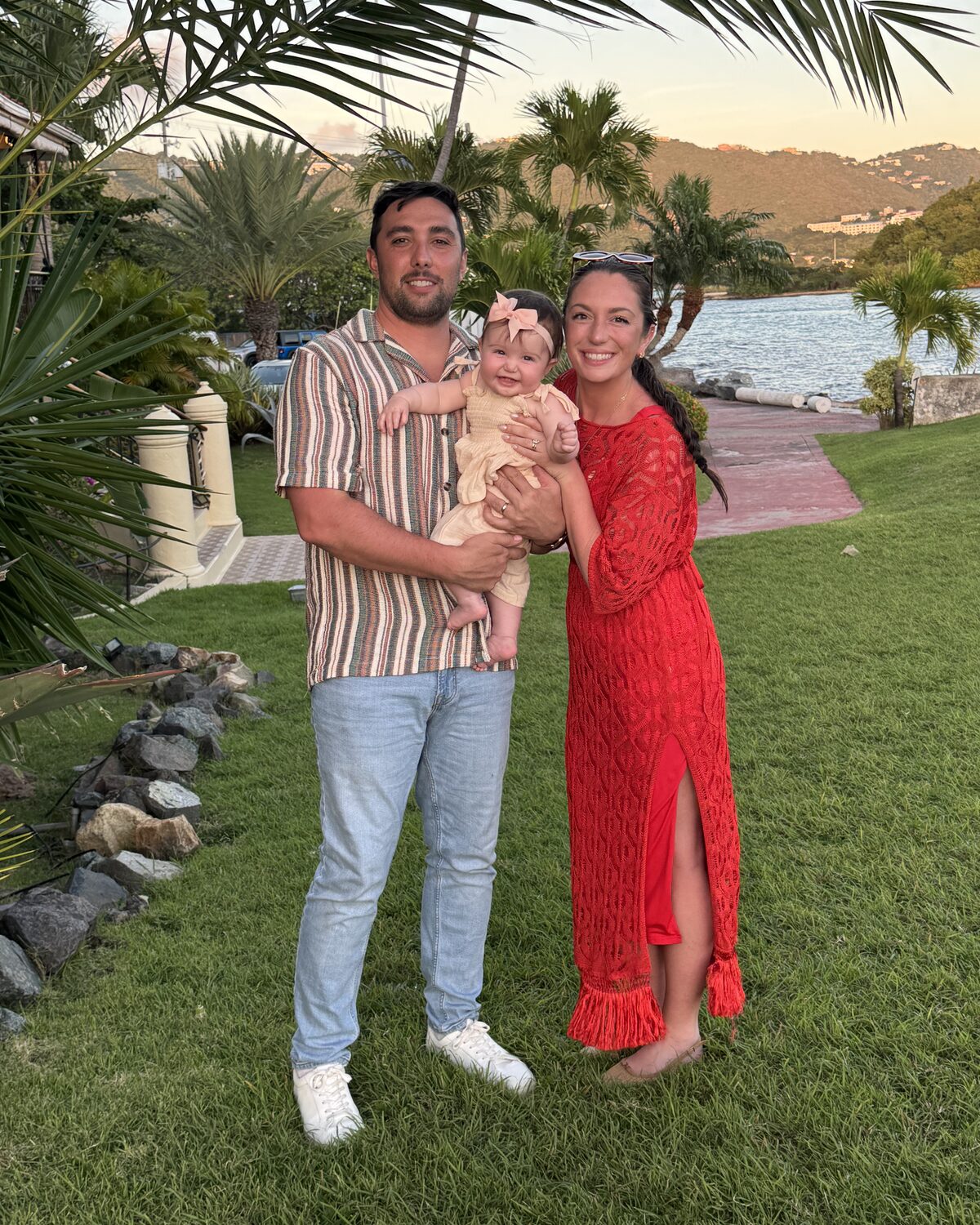 A family with their baby at sunset